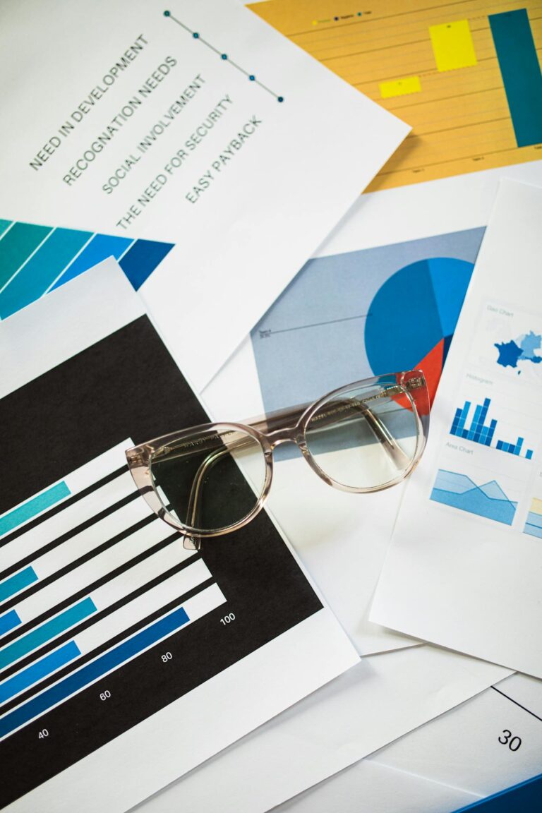 Maximizing Your Blog’s Reach: SEO Tips for Bloggers Eyeglasses resting on business charts and documents, ideal for financial analysis themes.